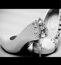Pair of white high heels covered in diamonds